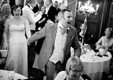Image of a newly wed couple laughing on the dance floor taken by Natasha Hirst.